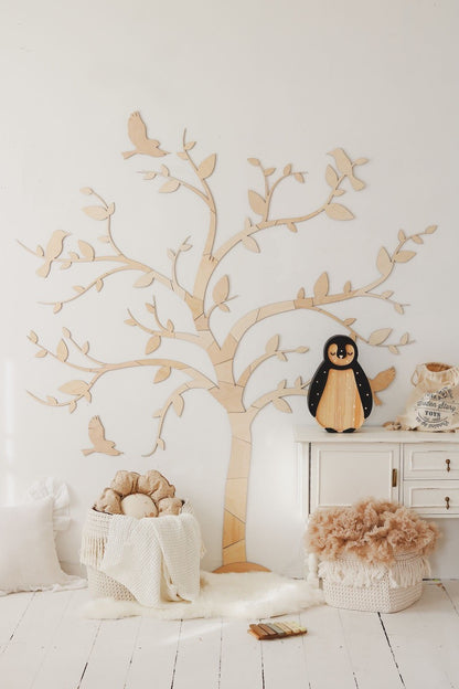 Natural wood tree and birds wall art showing crafted details in a scandinavian-style playroom setting